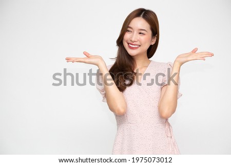 Happy Asian woman presenting or showing open hand palm with copy space for product isolated on white background