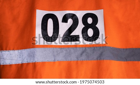 orange vest with reflectors and serial number
