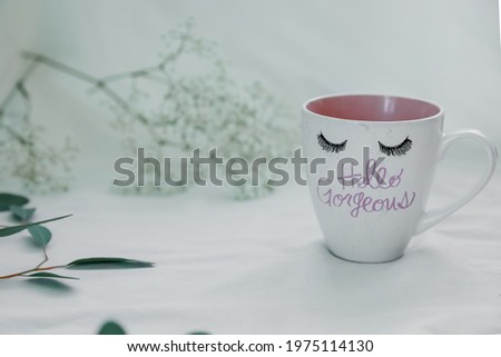 Self care morning concept. Coffee cup and flowers. Pastel colours.