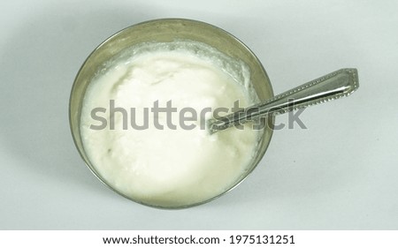 Bowl with yogurt on white background
