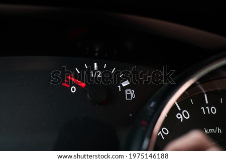 Dashboard of a car indicating that it is running out of fuel reserve Royalty-Free Stock Photo #1975146188