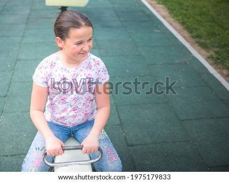 Cute little girl with long hair on see saw