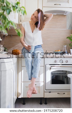 European woman brews coffee at home in her kitchen and enjoys her morning, good morning, caucasian woman makes coffee filter at home and enjoys her day off, woman does internet detox on her day off