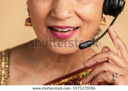 Indian operator assistant using a microphone headset while conversing with a customer