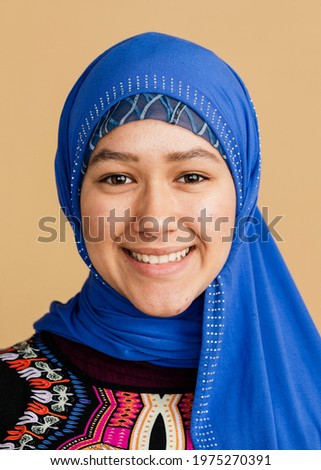 Happy Islamic woman in a blue hijab Royalty-Free Stock Photo #1975270391