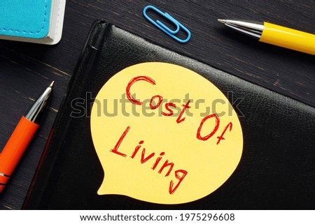 Financial concept about Cost Of Living with sign on the piece of paper. 
