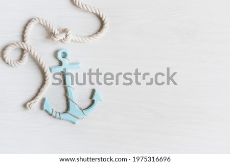 Sea background with anchor and marine rope on white wooden deck top view. Summertime sea background.