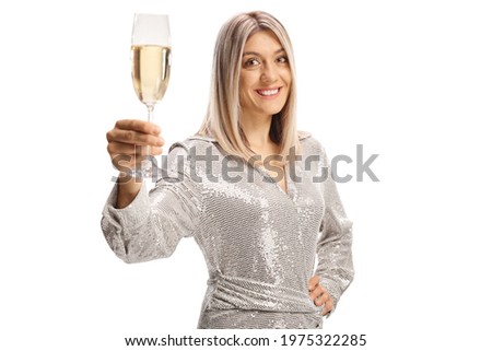 Elegant young woman in a dress toasting with a glass of sparkling wine isolated on white background