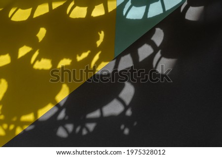 Minimalist light and shade composition on yellow, gray and blue. Abstract sunspots on a tricolor background.