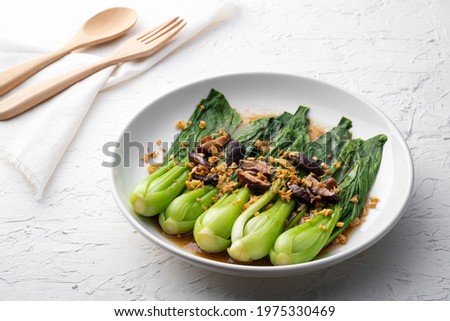 Baby Bok choy or chinese cabbage in oyster sauce with Shitake Mushrooms and fried garlic. Royalty-Free Stock Photo #1975330469