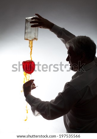 Man, pouring the wine into the glass on a gray background.