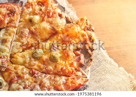 Healthy gluten-free pizza with beef. Gluten-free cooking class. Cooking at home. Pizza on a linen napkin on a wooden background. 