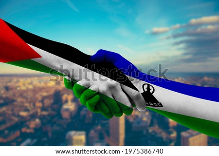 Shaking hands Palestine and Lesotho
