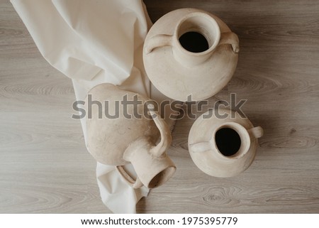 clay pots on stone wall in a traditional mediterranean house Royalty-Free Stock Photo #1975395779