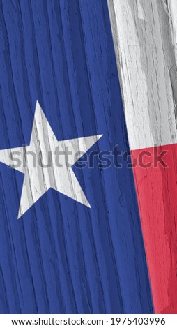 Texas state flag on dry wooden surface. Vertical bright background. Mobile phone wallpaper made of old wood. The symbol of one of the American states. Lone Star State. Solar lighting with hard shadows