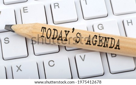 TODAY'S AGENDA text on pencil on keyboard background