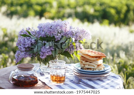 breakfast in the garden - Belgian waffles and cup with tea
