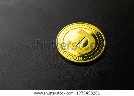 Dogecoin crypto currency on black background close-up view, one golden coin, business and finance concept photo