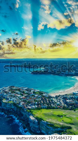 Aerial view of Bondi Beach coastline from helicopter at sunset, Australia