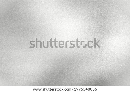 Light shining on silver painted metal wall with copy space, abstract texture background