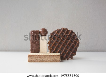 Abstract geometric composition of sweet food with different shapes - wafers, candy and cookies. Art and balance symbol.
