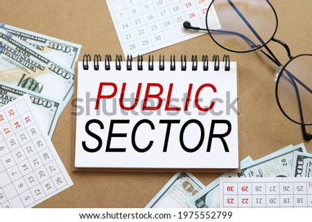 Public sector. text on white notepad paper near calendar on wood craft background