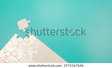 Selective focus piece of jigsaw puzzle with a green background