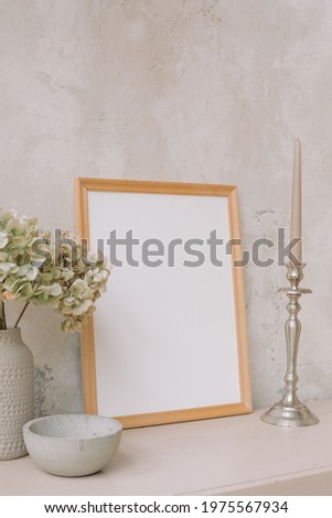 Blank photo frame with copy space on table. Comfortable modern interior design.