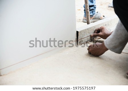 Construction worker doing his job -  using fine replacement snap line preparing to pouring concrete floor
