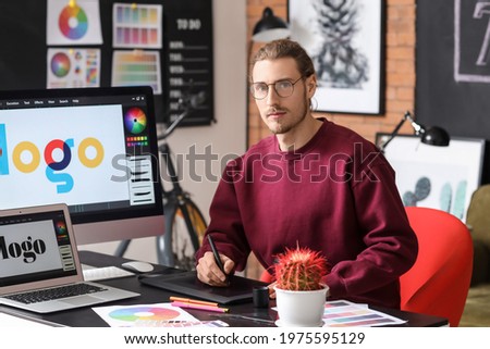 Young male designer working in office