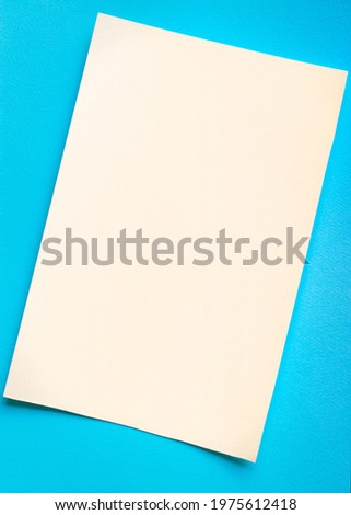 Blue and milky minimalistic background. Paper in two colors. Texture backdrop. Concept of contrast and minimalism.
