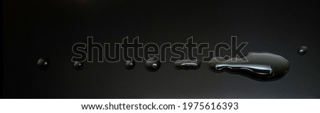 water drops on the surface of a LCD screen, macro shoot, dark mood, banner