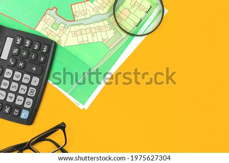 Real estate concept flat lay background, mortgage and searching land for sale workspace with cadastral map, copy space and top view photo