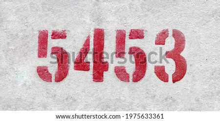 Red Number 5453 on the white wall. Spray paint.