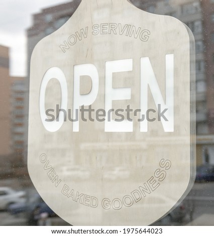 A sticker on the doors of the store with the inscription open.