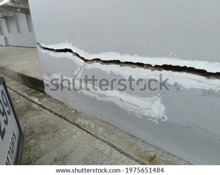 Non-standard construction cracks which affects the safety of the building And must be corrected as quickly as possible. Royalty-Free Stock Photo #1975651484