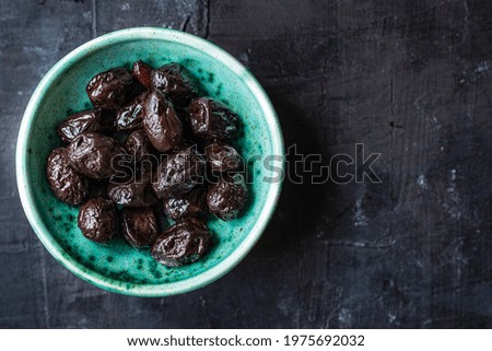dried olive sun-dried aromatic olives dry fruit appetizer or salad addition on the table healthy food meal snack copy space food background rustic. top view