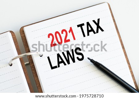 Wooden notebook with text 2021 tax laws, concept