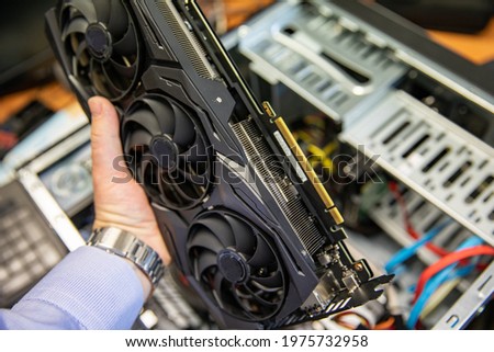 Large video card for your computer. Mining. Royalty-Free Stock Photo #1975732958