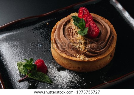 Delicious chocolate tart with raspberry