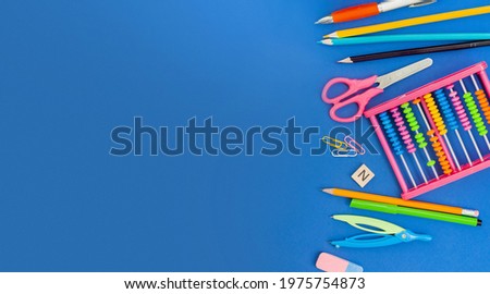 various school supplies for study on a blue background. copy space. concept back to school
