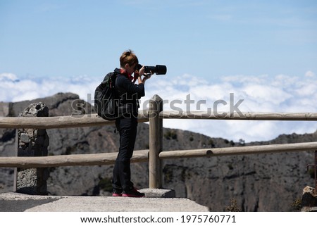 Photographer taking a picture in high altitude Irazu national park in Costa Rica.
