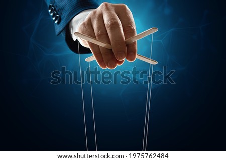 The puppeteer's hand is large. The concept of world conspiracy, world government, manipulation, world control Royalty-Free Stock Photo #1975762484