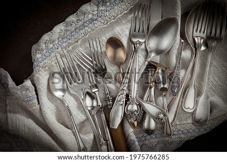 Silver dishes on old background Royalty-Free Stock Photo #1975766285