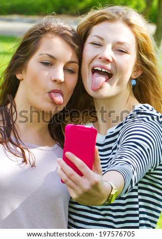 Two girls making a funny selfie