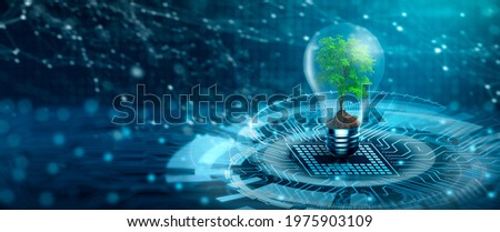 Tree with soil growing on Light bulb. Digital Convergence and and Technology Convergence. Blue light and network background. Green Computing, Green Technology, Green IT, csr, and IT ethics Concept. Royalty-Free Stock Photo #1975903109