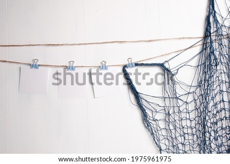Clothes pin holding sheets of paper isolated over a white background
