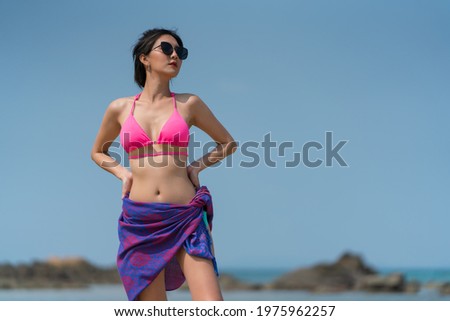 Portrait of thai woman posing outdoors at the sea beach