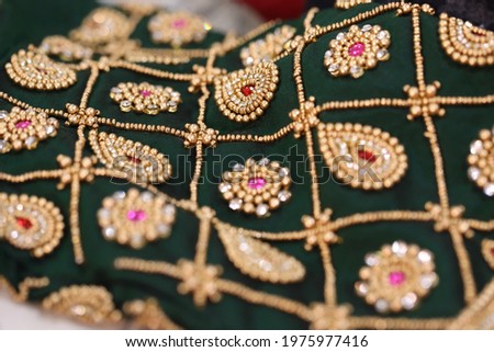 handcrafted intricate aari and chumki work in a silk fabric Royalty-Free Stock Photo #1975977416
