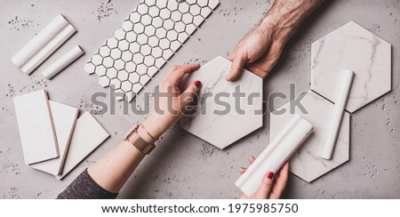 Interior design and home decoration - different shapes of white ceramic and gres tiles. Designer choosing bathroom or kitchen renovation materials. Captured from above (top view, flat lay). Royalty-Free Stock Photo #1975985750